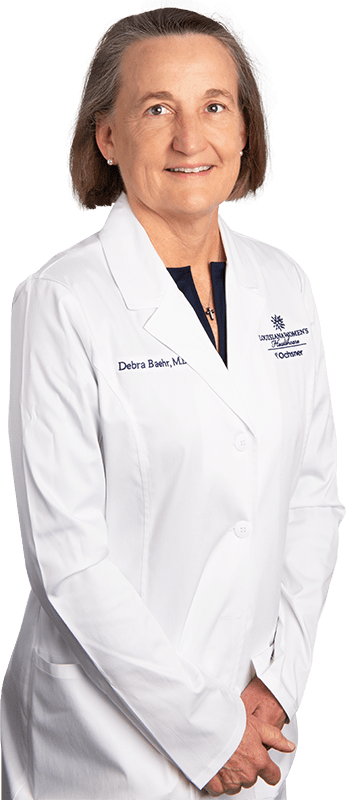 Photo of Dr. Debra Baehr standing in white lab coat