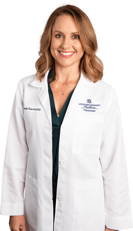 Photo of Dr. Nicole Chauvin standing and smiling in white lab coat
