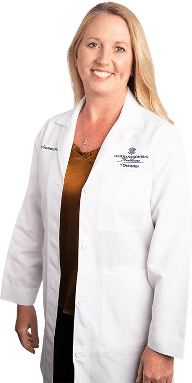 Photo of Dr. Lisa Gautreau standing and smiling in white lab coat